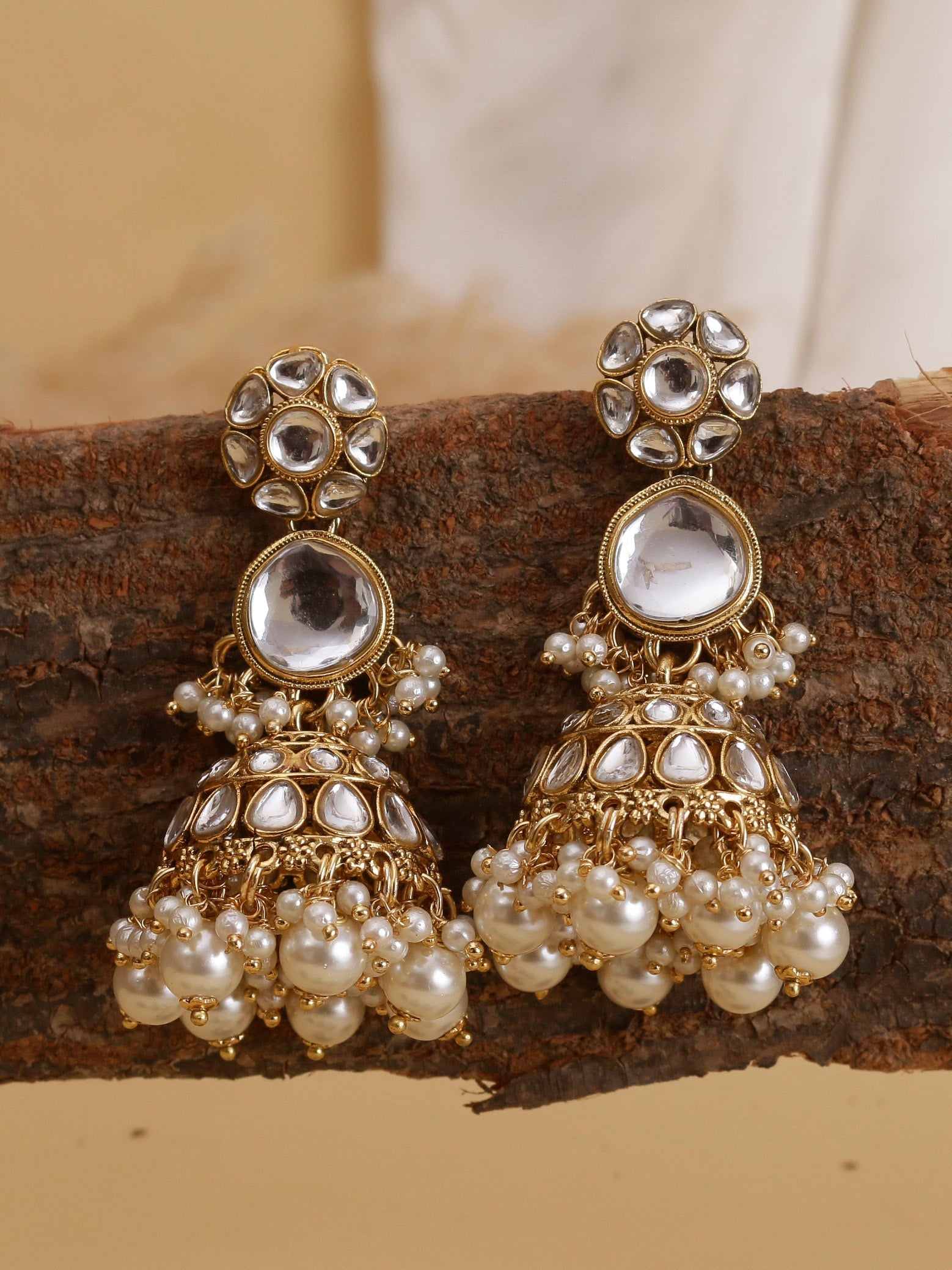 Swisni Alloy Golden Jhumki Earrings with White Beads